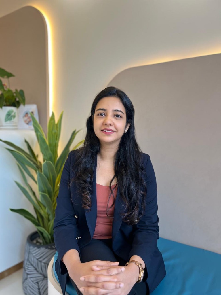 Dr. Sejal Kulkarni smiling warmly in her clinic