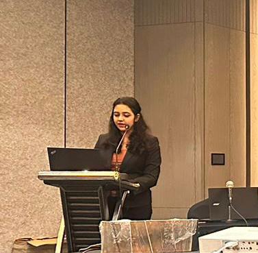 Dr. Sejal Kulkarni presenting at a medical conference at a podium